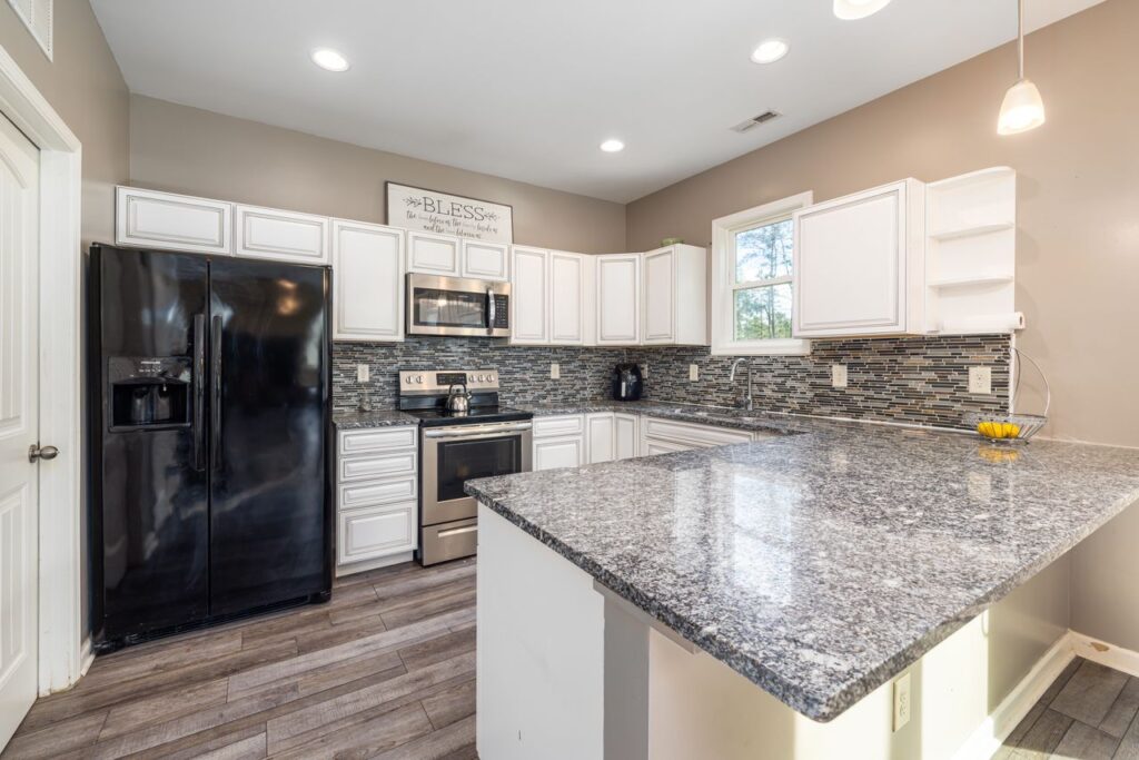 Elegant kitchen with sleek granite countertops and black appliances, perfect for San Antonio living.